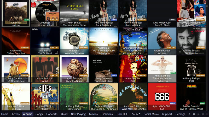 QSYNC Media Player albums library grid showing cover art with a per-album format badge reading QUAD, SURROUND, ATMOS or STEREO on every tile